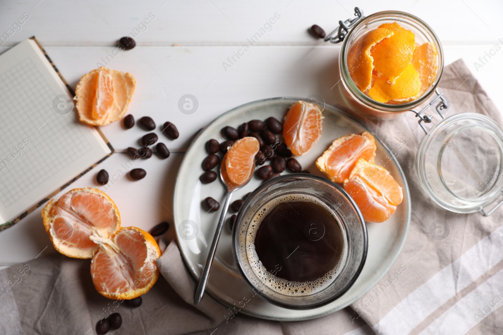 Photo of Flat lay composition with many fresh ripe tangerines and book on white wooden table