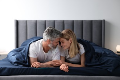 Photo of Lovely mature couple in bed at home