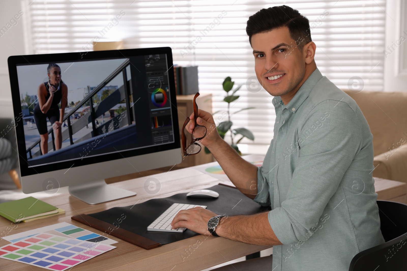 Photo of Professional retoucher working on computer in office