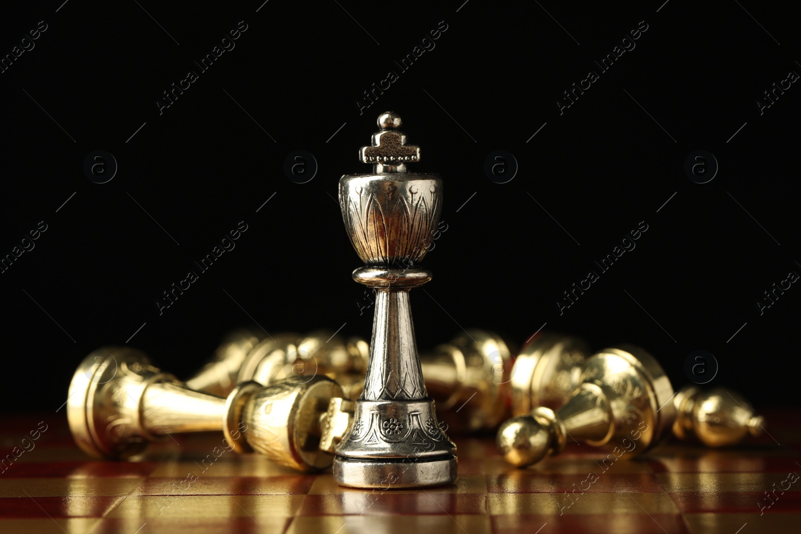 Photo of Chessboard with game pieces on black background