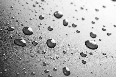 Photo of Many clean water drops on black background