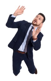 Photo of Handsome bearded businessman in suit avoiding something on white background, above view