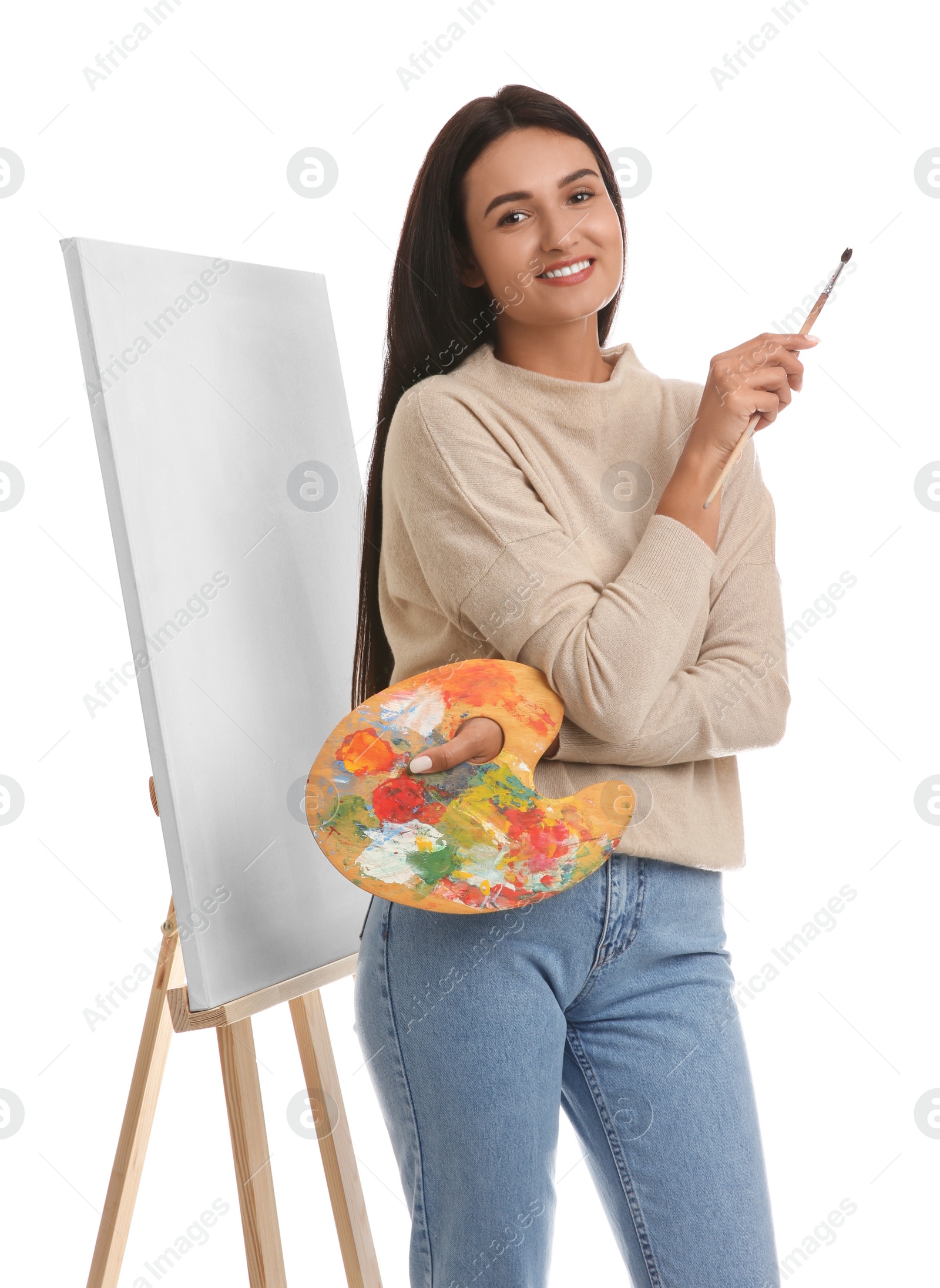 Photo of Young woman with drawing tools near easel on white background