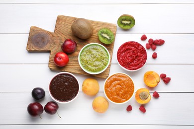 Photo of Different puree in bowls and fresh fruits on white wooden table, flat lay