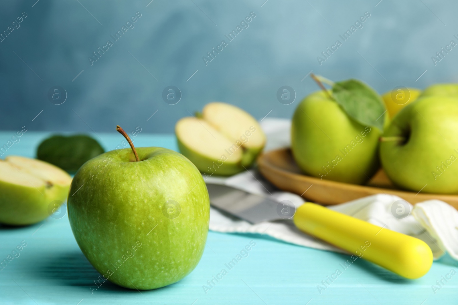 Photo of Composition with fresh ripe green apples on blue wooden table, space for text