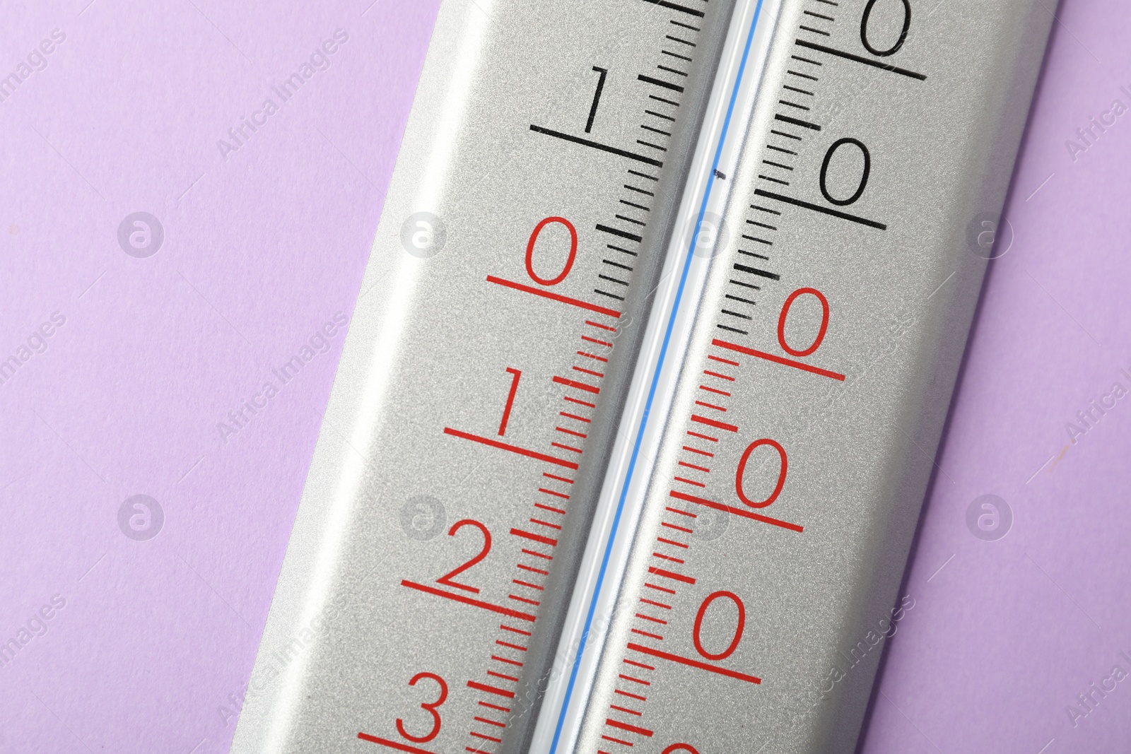 Photo of Modern weather thermometer on lilac background, closeup