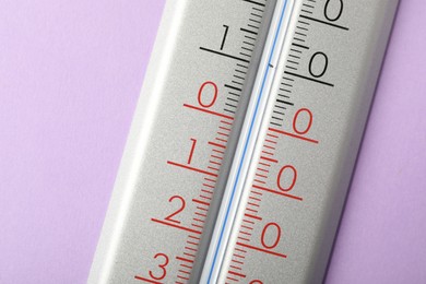 Photo of Modern weather thermometer on lilac background, closeup