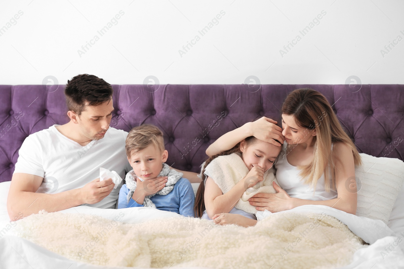 Photo of Family suffering from cold in bed at home