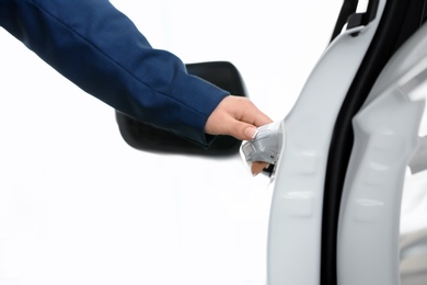 Young woman opening door of new car, closeup