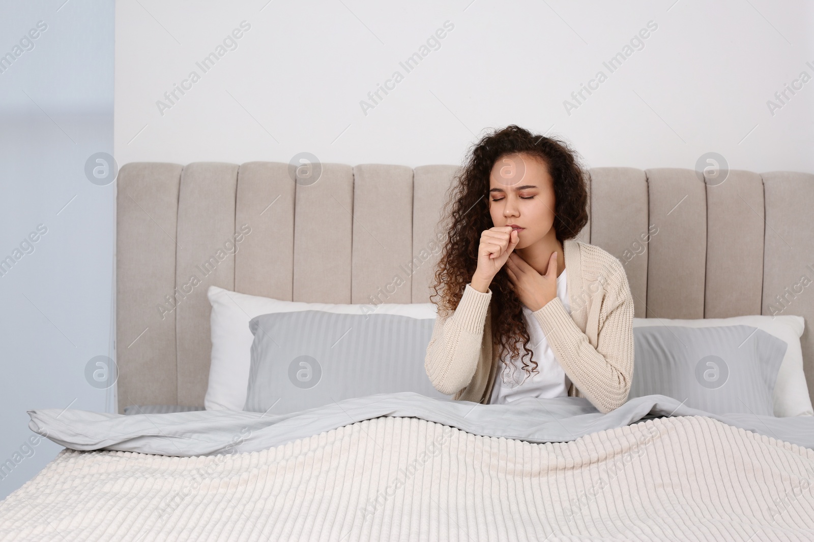 Photo of Sick African American woman in bed at home