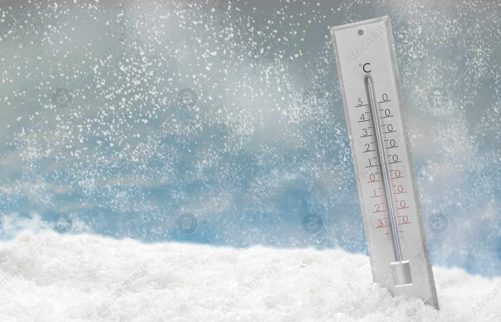 Image of Thermometer in snow showing temperature below zero outdoors on winter day