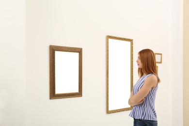 Photo of Woman viewing exposition in modern art gallery