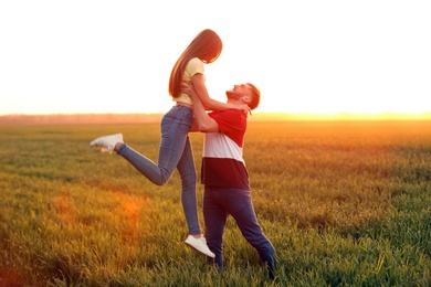 Photo of Happy young couple in green field on sunny spring day