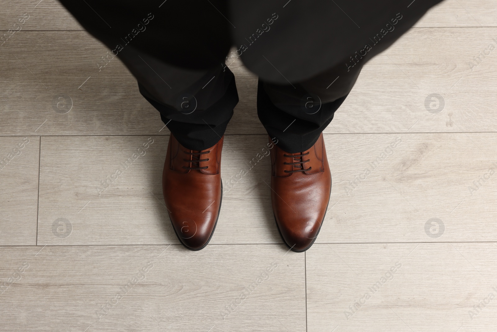 Photo of Businessman in elegant leather shoes on floor, above view