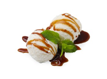 Photo of Scoops of ice cream with caramel sauce and mint leaves isolated on white