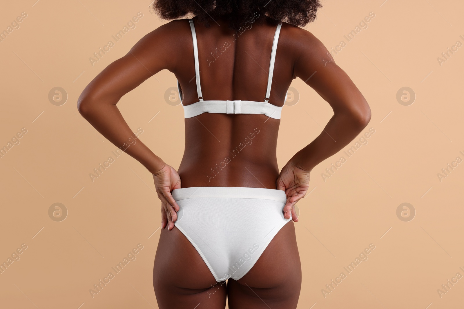 Photo of Woman in stylish bikini on beige background, closeup