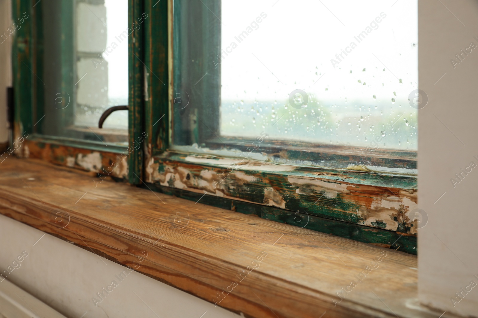 Photo of Old window with wooden sill in room, closeup