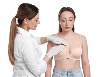 Mammologist checking woman's breast on white background