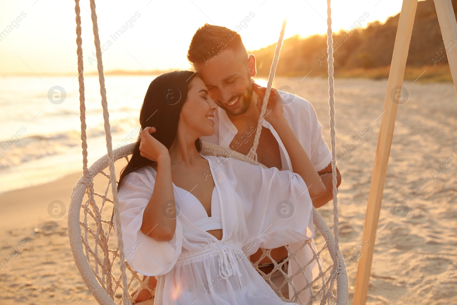 Photo of Happy young couple on beach at sunset