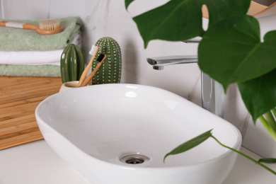 Stylish vessel sink on light countertop in modern bathroom