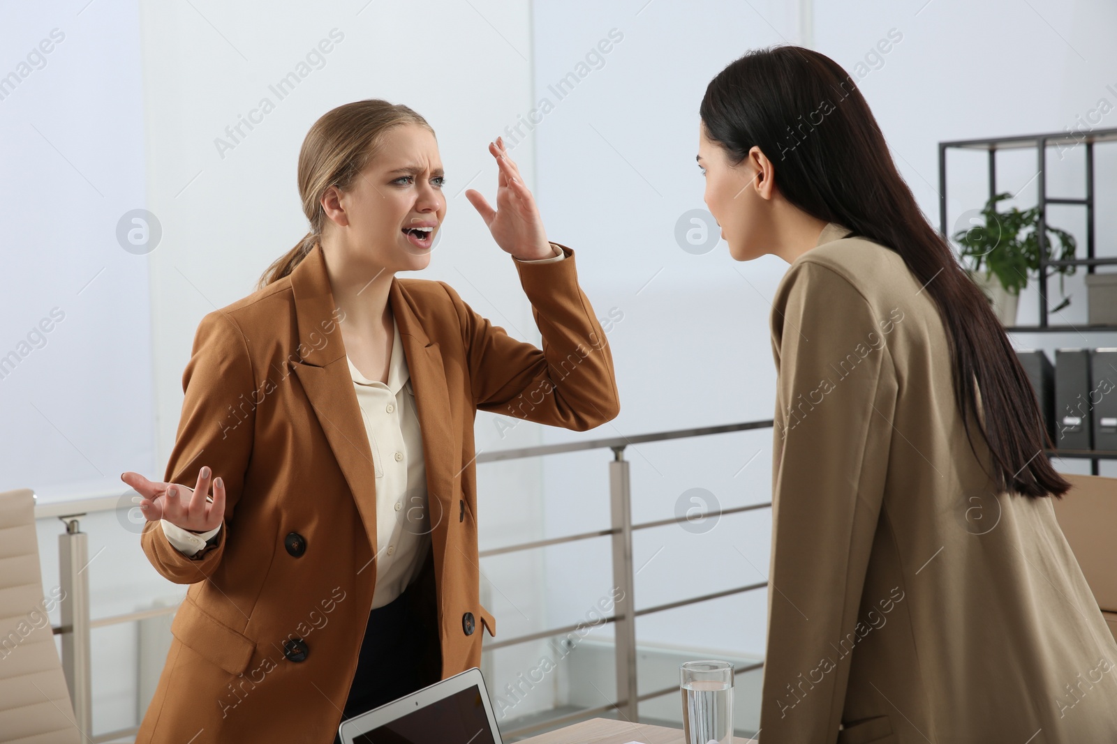 Photo of Emotional colleagues arguing in office. Toxic work environment