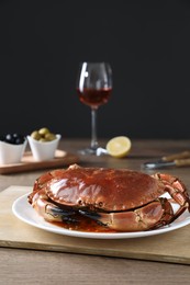 Delicious cooked crab served on wooden table