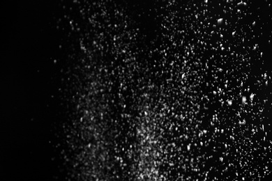 Snow flakes falling on black background. Winter weather