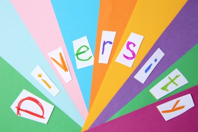 Word Diversity made of paper with letters on color background, flat lay