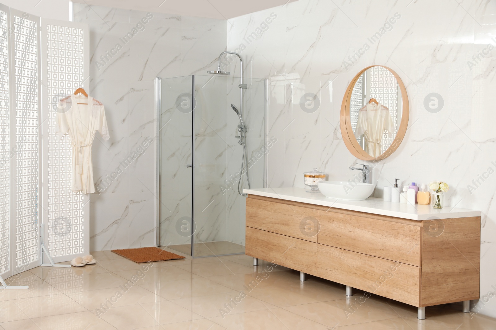 Photo of Modern bathroom interior with shower stall and folding screen