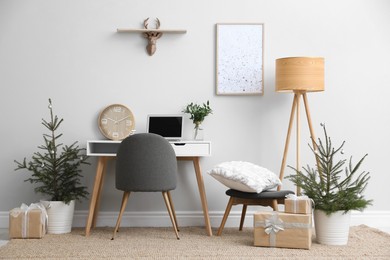 Photo of Stylish room interior with potted fir trees decorated for Christmas