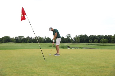 Man playing golf on green course. Sport and leisure
