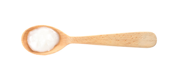 Photo of Organic coconut oil in wooden spoon isolated on white, top view. Healthy cooking