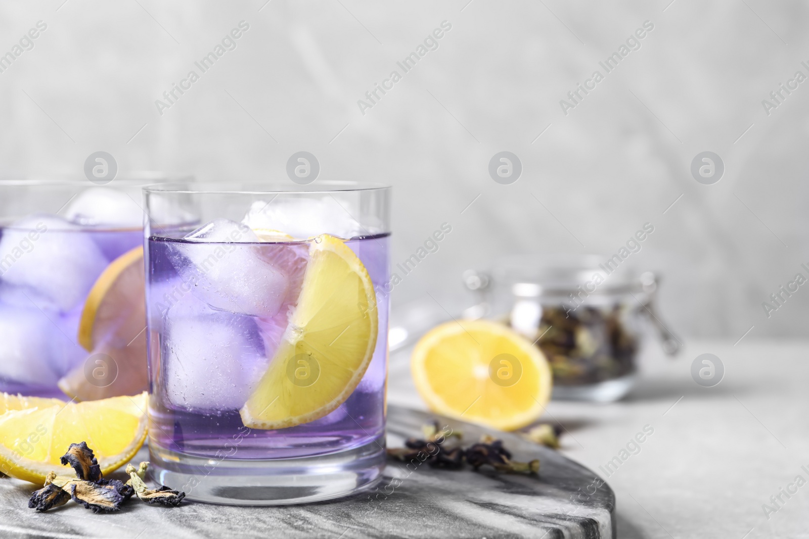 Photo of Organic blue Anchan and lemon on table, space for text. Herbal tea
