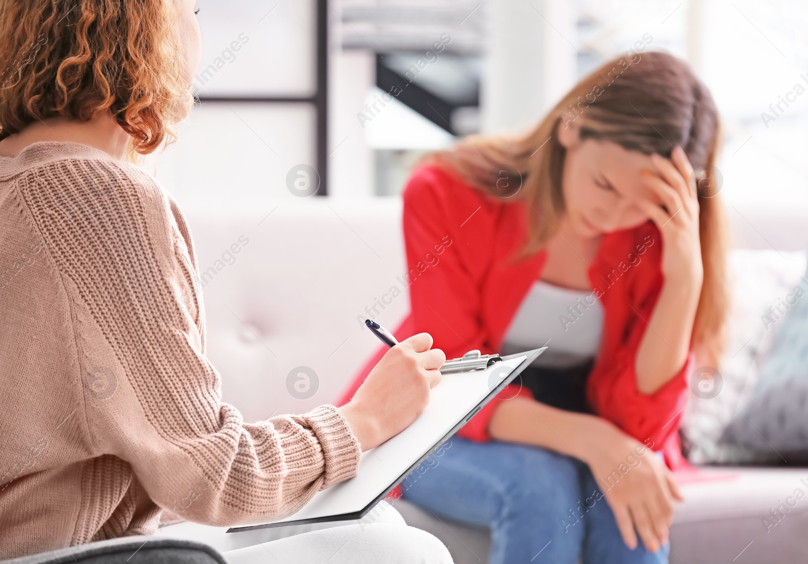 Photo of Child psychologist working with teenage girl in office