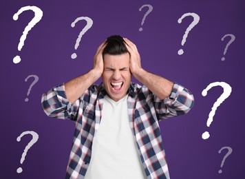 Amnesia. Stressed man and question marks on purple background