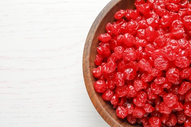 Bowl of tasty cherries on wooden background, top view with space for text. Dried fruits as healthy food