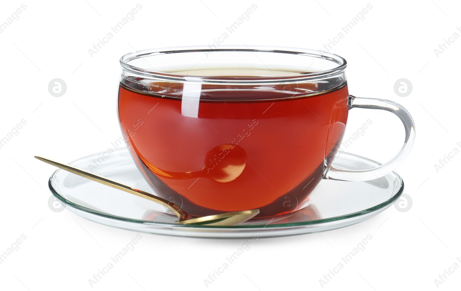 Photo of Aromatic tea in glass cup and golden spoon isolated on white