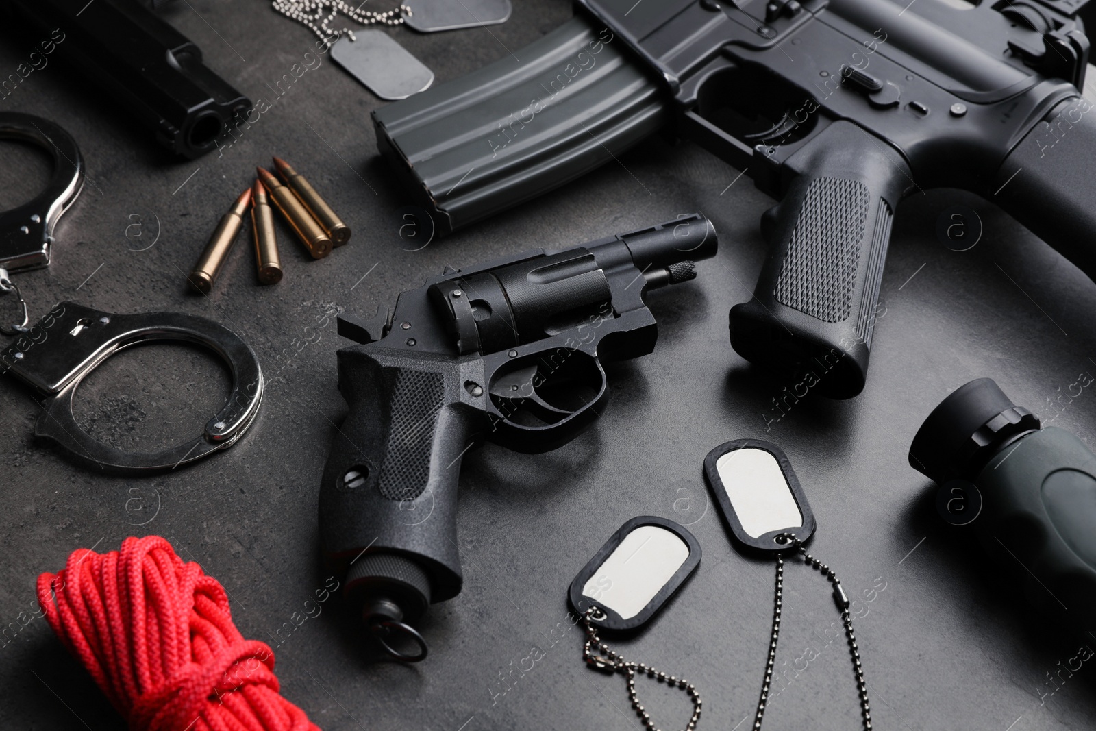 Photo of Composition with gun and bullets on stone table