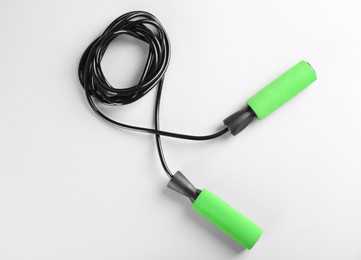 Photo of Skipping rope on white background, top view. Sports equipment