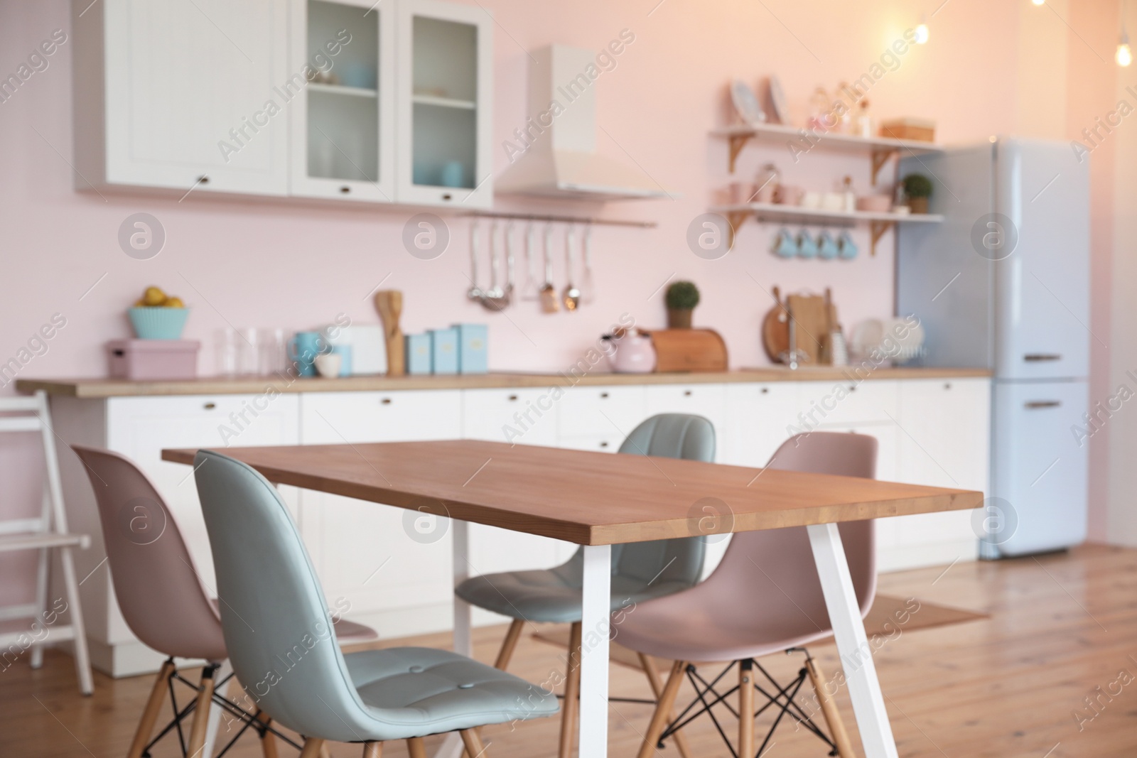 Photo of Stylish kitchen interior with dining table and chairs