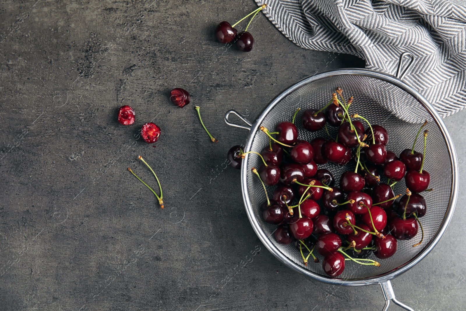 Photo of Sieve with sweet red cherries on table, top view