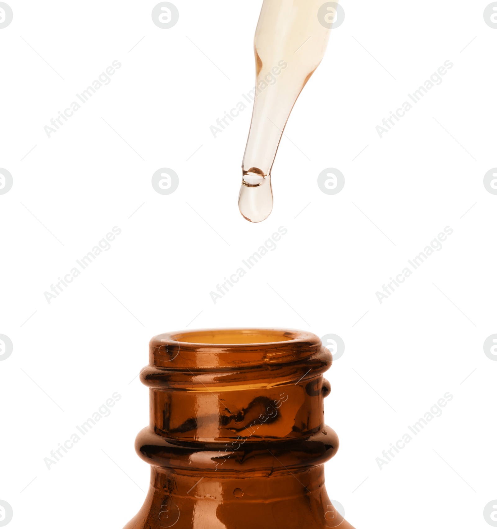 Photo of Essential oil dripping from pipette into glass bottle on white background