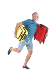 Photo of Senior man with suitcases running on white background. Vacation travel