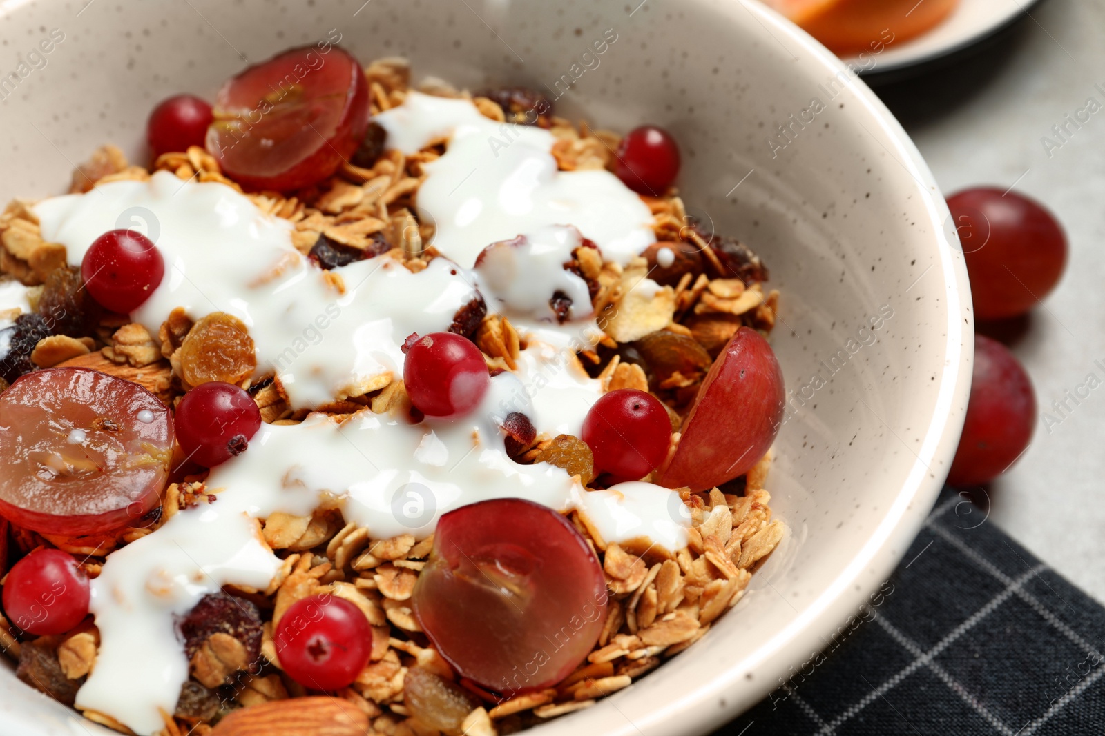 Photo of Tasty granola with berries on table, closeup. Healthy breakfast