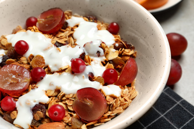 Tasty granola with berries on table, closeup. Healthy breakfast