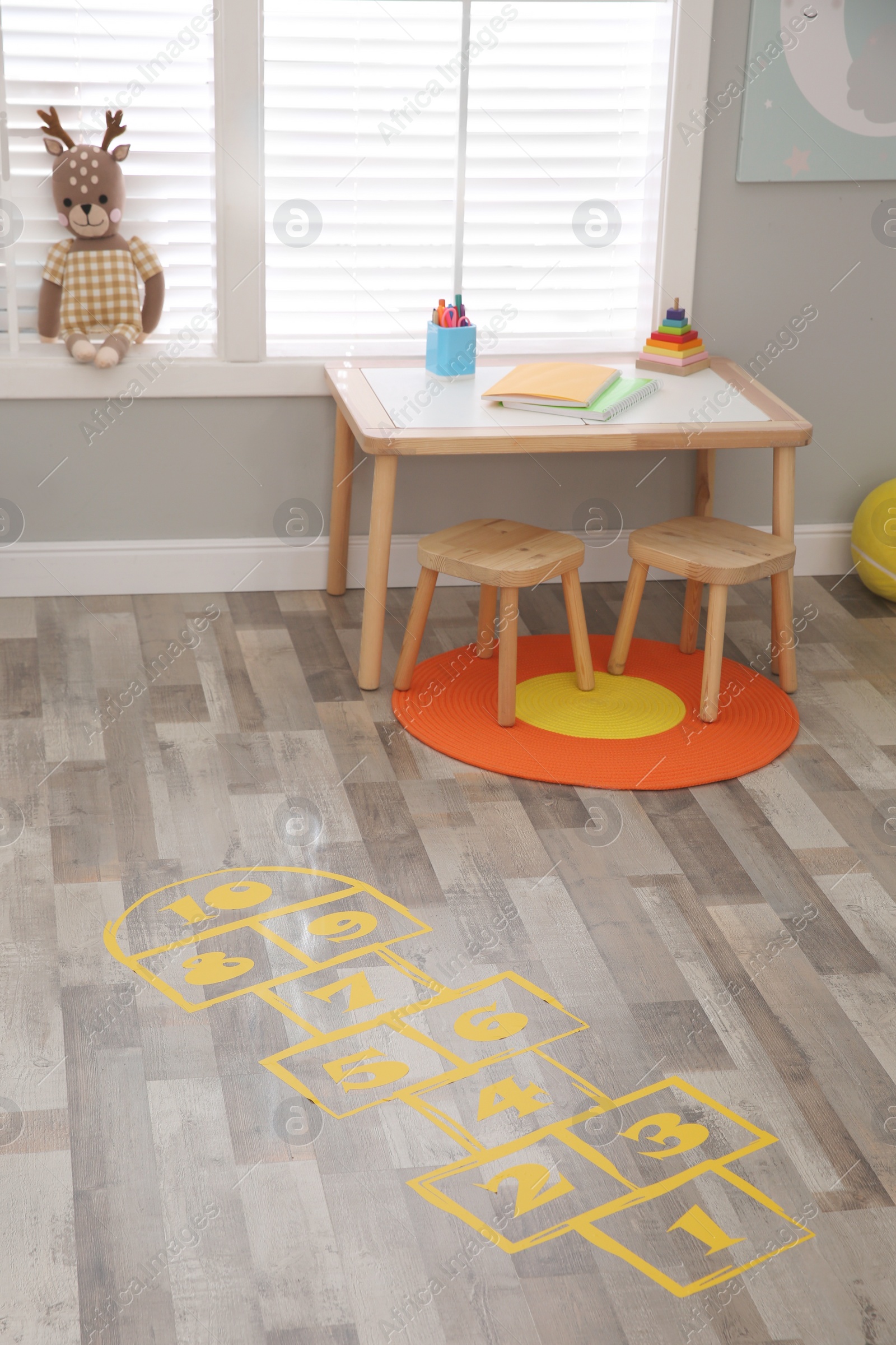 Photo of Yellow hopscotch floor sticker in room at home