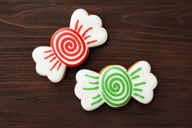 Photo of Candy shaped Christmas cookies on wooden table, flat lay