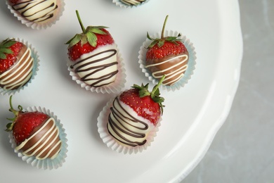 Photo of Dessert stand with chocolate covered strawberries on grey background, top view