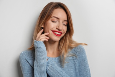 Photo of Beautiful young woman in warm sweater on white background