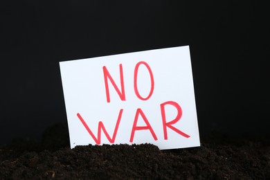 Card with words No War in soil